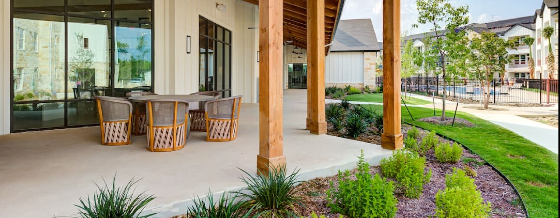 spacious outdoor patio of property including chairs and nature